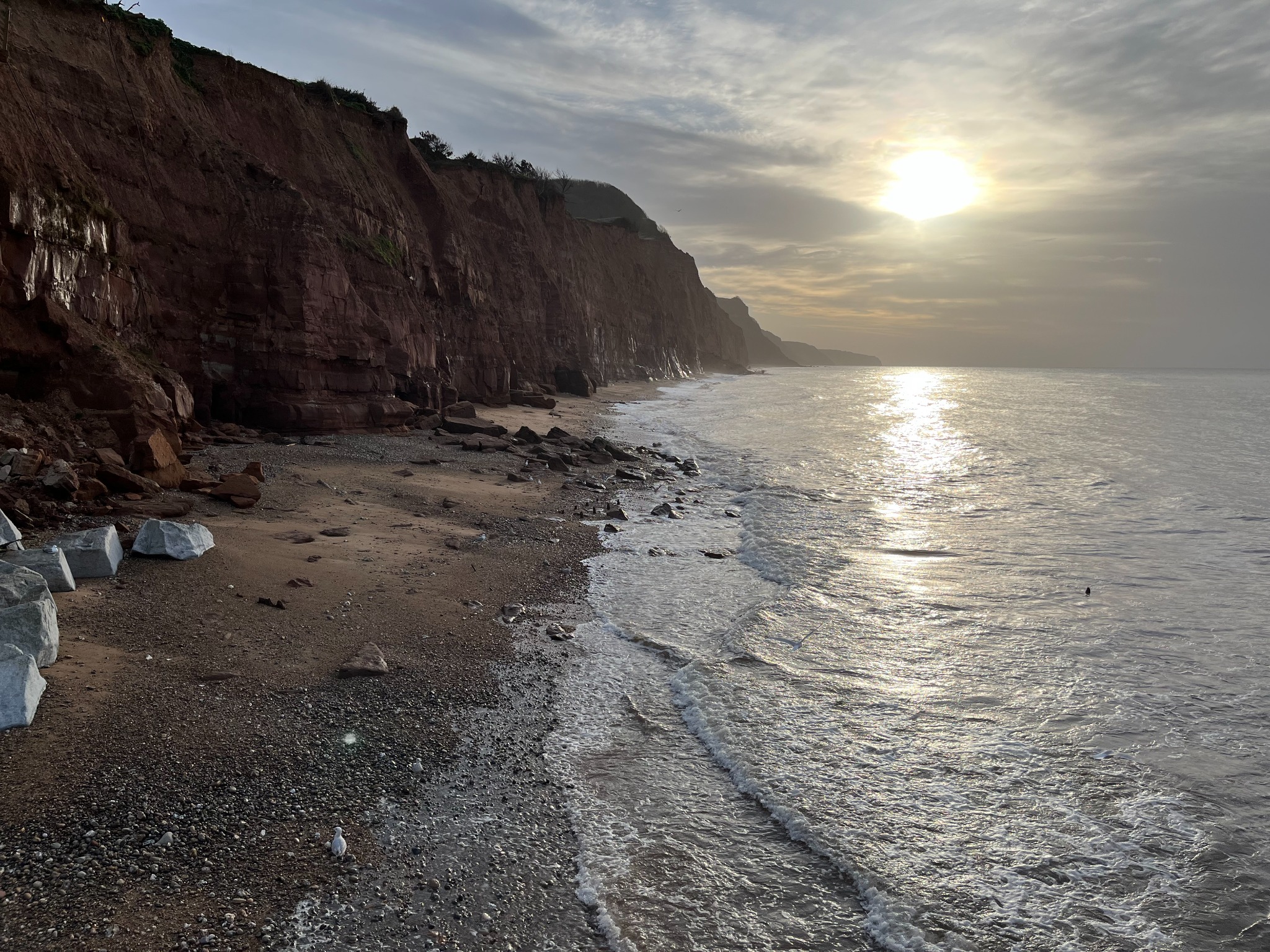 Red cliffs and shoreline in low light